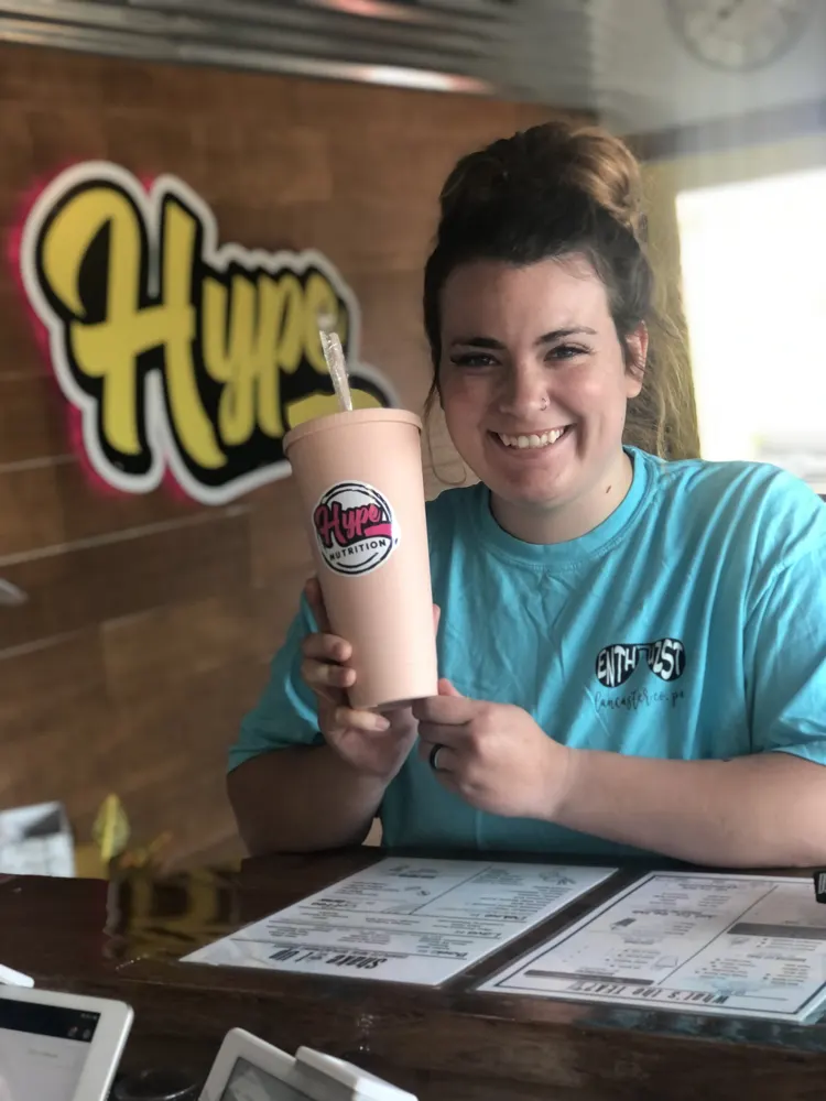 A customer with her Hype drink at the counter