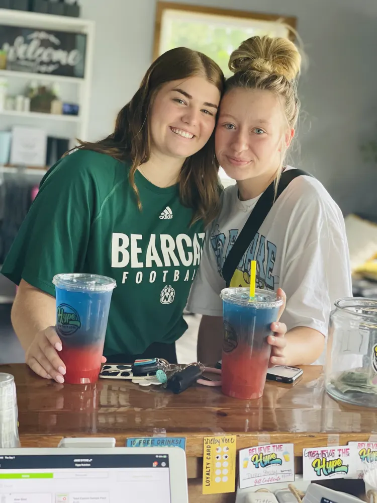Two friends with layered Hype drinks