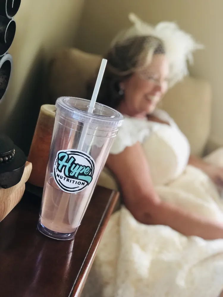 A bride in her wedding dress with a Hype drink