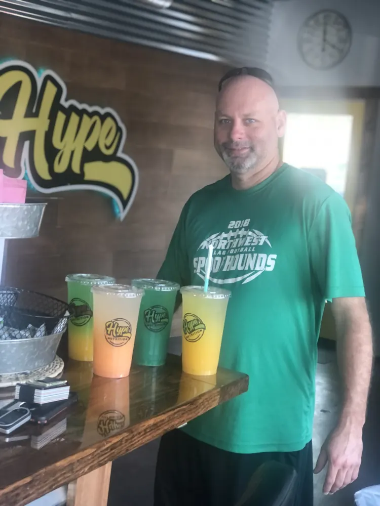 A customer with a tray of Hype drinks