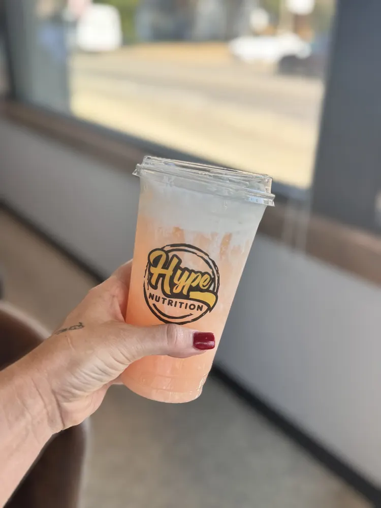 A peach Hype drink by the window