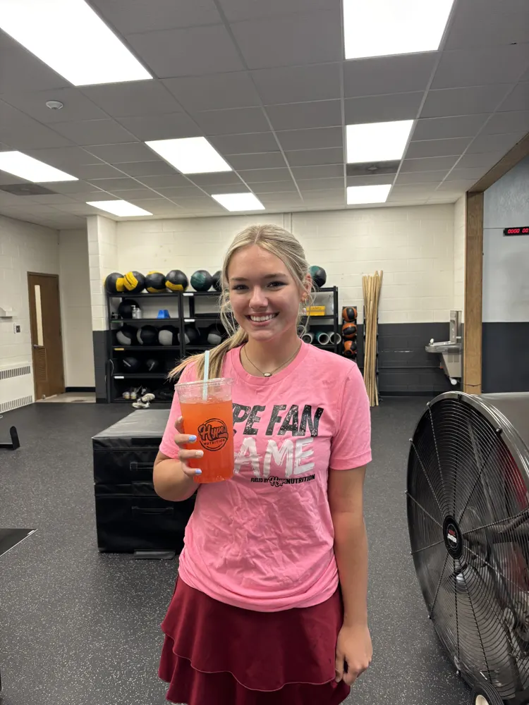 A Hype Fan of the Game in her pink shirt with a Hype drink