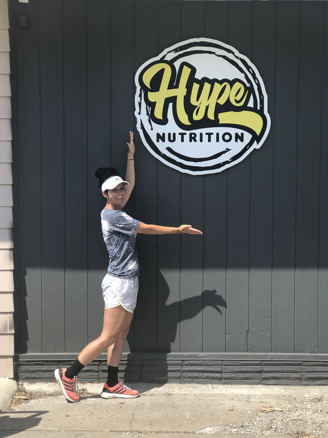 Reba pointing up at the first Hype Nutrition sign