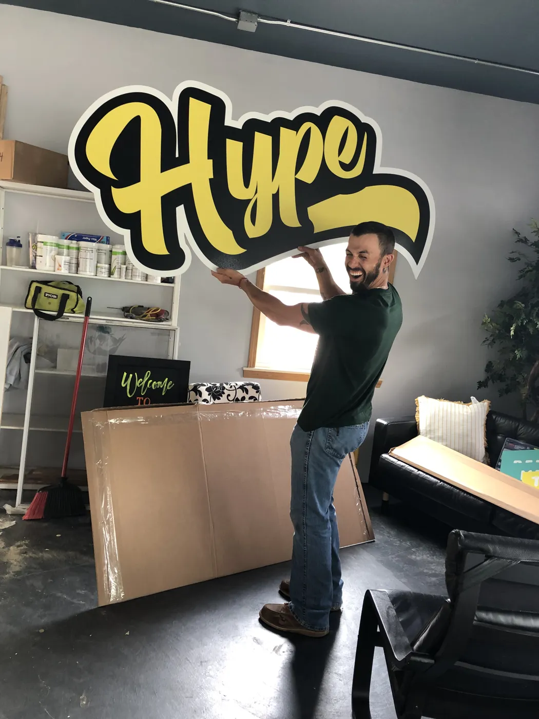 Jake hanging the Hype sign in the shop
